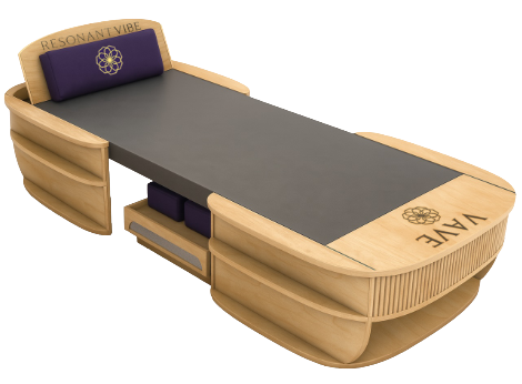 VAVE Frequency Therapy Bed VAVE frequency therapy bed with wooden frame and cushions, designed for full-body sound and vibration sessions.